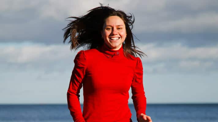 young woman running red sweater