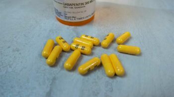 orange Gabapentin pills on a table - What Happens If You Mix Gabapentin And Alcohol?