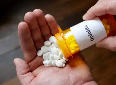 Opioid pills being poured out onto hand